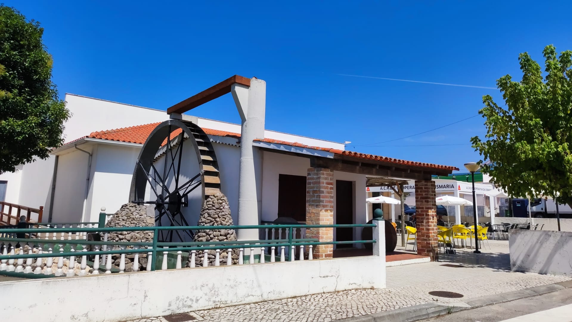 The ACRDC Sismaria association building with its iconic water wheel.
